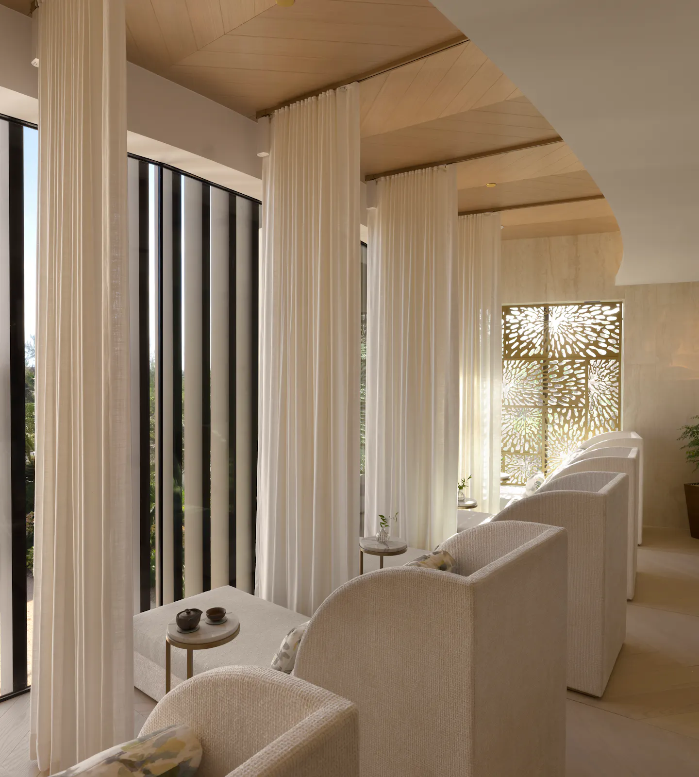 Quiet Lounge with relaxation day beds and floor to ceiling windows at Meraki Wellness