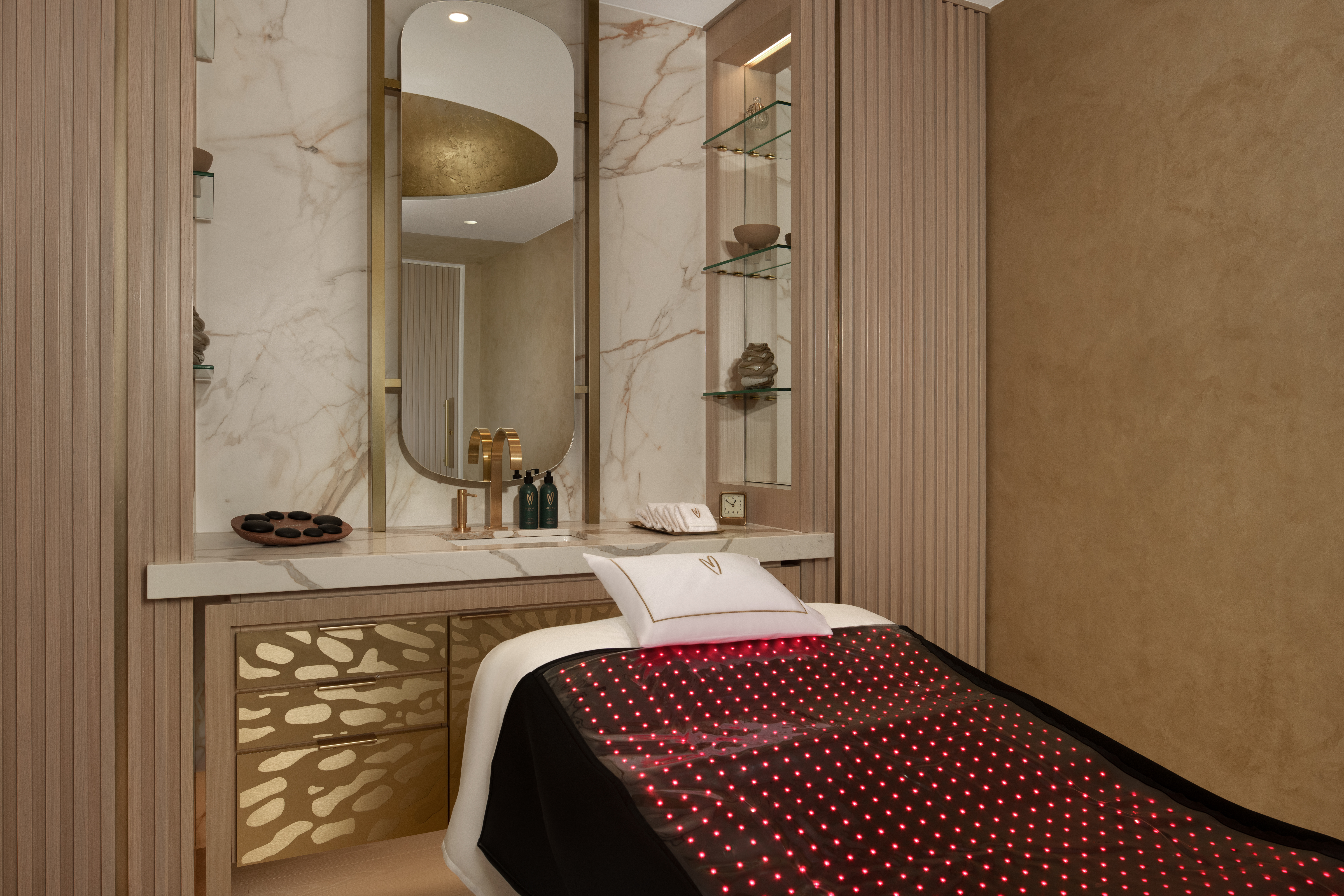 treatment suite with red light therapy mat on the treatment bed