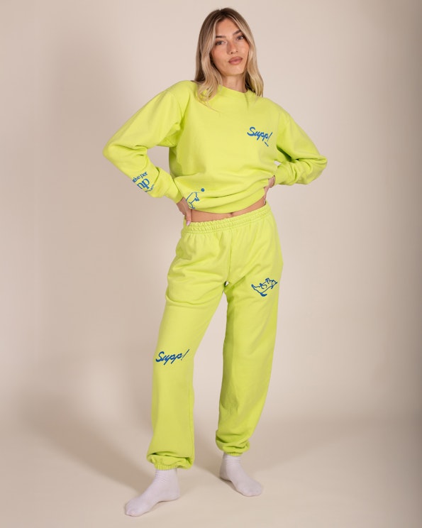 Custom printed neon yellow-green fleece sweat set with blue script logo and graphic details, produced by MerchCamp for Native Pet