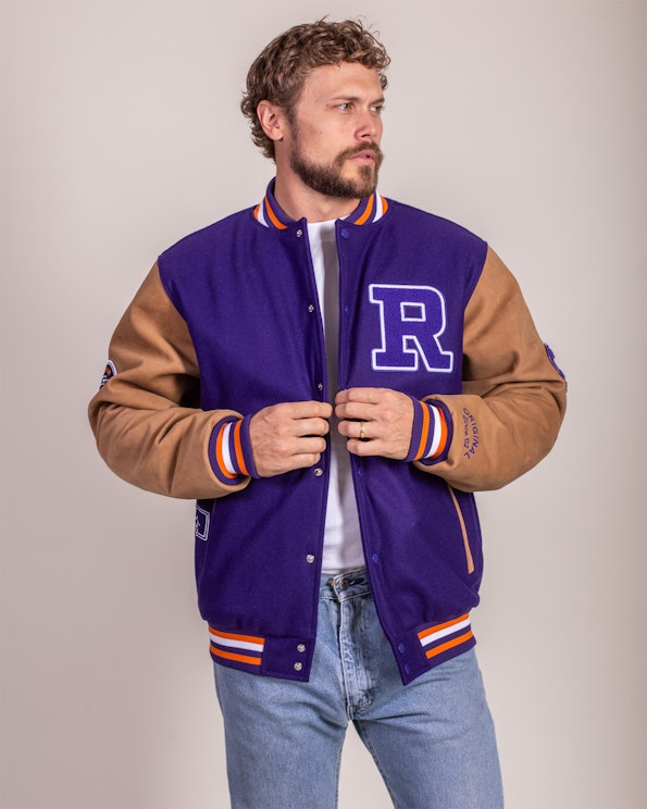 Full custom purple wool varsity jacket with tan leather sleeves and chenille R patch, produced by MerchCamp for Roku