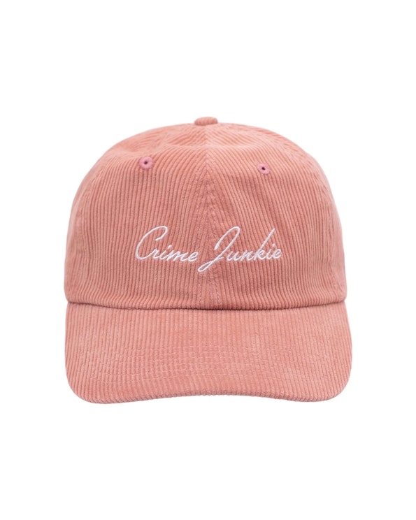 Embroidered dusty pink corduroy dad hat with white cursive script lettering, produced by MerchCamp for Audiochuck