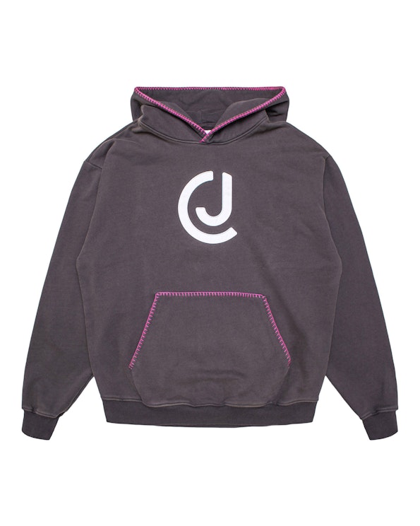 Full custom charcoal fleece hoodie with white CJ logo and pink contrast stitching, produced by MerchCamp for Audiochuck