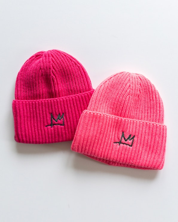 Full custom ribbed knit beanies in hot pink and coral with embroidered crown logo, produced by MerchCamp for Eleanor