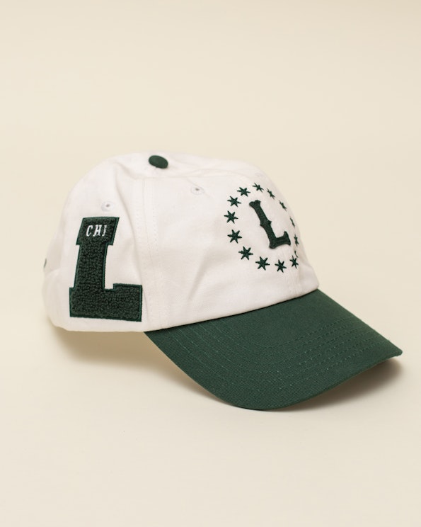 Full custom two-tone dad hat with chenille letter patches, star embroidery, and green brim, produced by MerchCamp for Lollapalooza