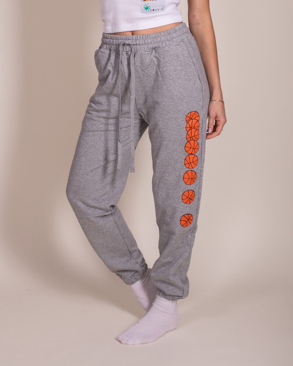 Custom heather grey fleece sweatpants with orange basketball graphic print down the leg, produced by MerchCamp for LA Clippers