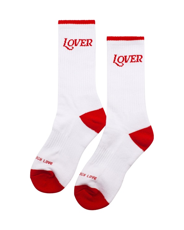 Full custom white ribbed crew socks with red "LOVER" lettering and red heel-toe accents, produced by MerchCamp for Ruben Rojas