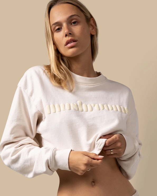 Puff printed cream crewneck sweatshirt with tonal raised lettering and cropped hem, produced by MerchCamp for Alice Mushrooms