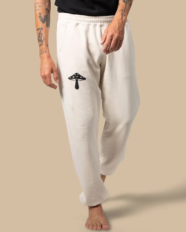 Printed off-white fleece sweatpants with black mushroom graphic and elastic waistband, produced by MerchCamp for Alice Mushrooms