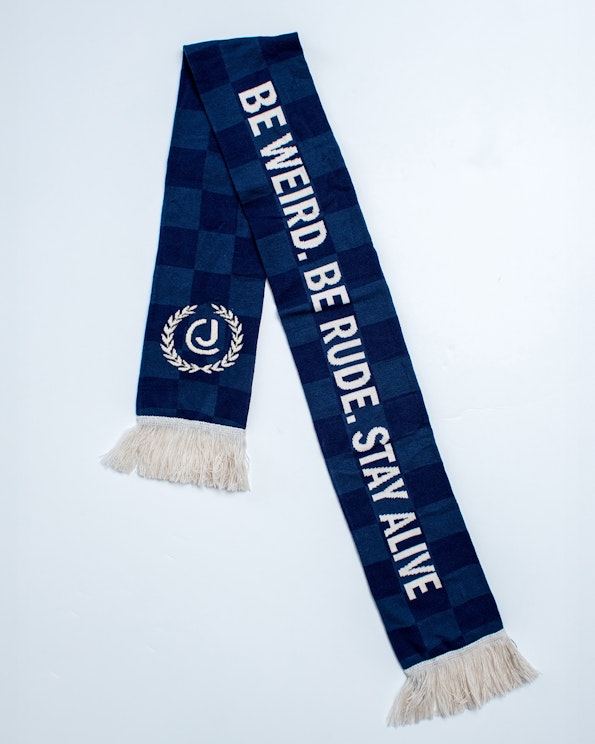 Full custom navy checkered knit soccer scarf with white fringe and laurel crest logo, produced by MerchCamp for Audiochuck