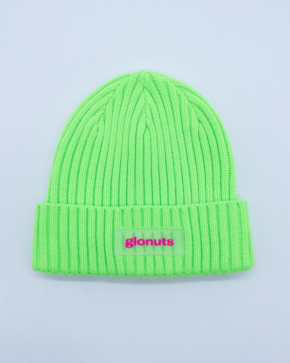 Full custom neon green ribbed knit beanie with hot pink PVC logo patch, produced by MerchCamp for Glonuts