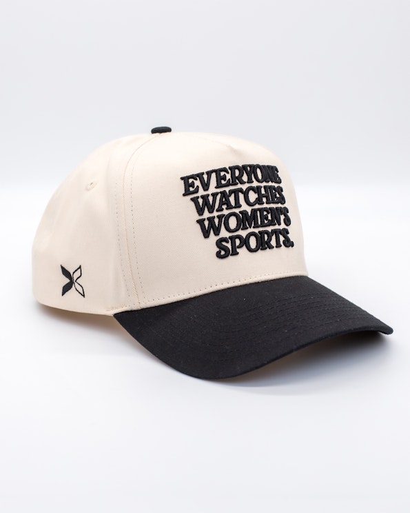 Embroidered cream and black snapback cap with bold women's sports slogan text, produced by MerchCamp for Togethxr