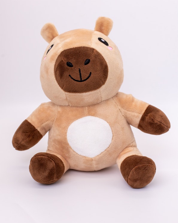 Custom plush capybara toy in tan and brown fleece with embroidered face and white belly, produced by MerchCamp for SuiFrens