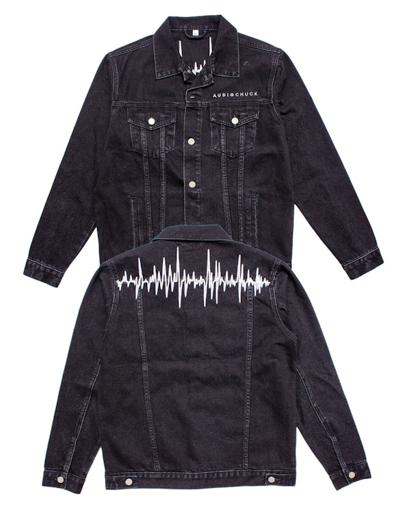 Full custom black denim jacket with white soundwave embroidery and chest branding, produced by MerchCamp for Audiochuck