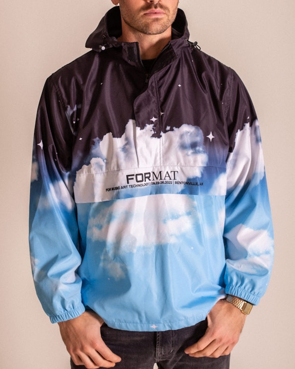 Full custom sublimated nylon anorak jacket with night-to-day sky and cloud graphics, produced by MerchCamp for Live Nation