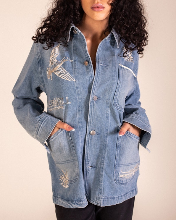 Full custom light-wash denim chore jacket with embroidered duck and cattail motifs, produced by MerchCamp for Live Nation
