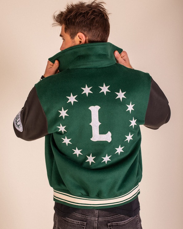 Full custom green wool letterman jacket with leather sleeves and star-circle back design, produced by MerchCamp for Lollapalooza