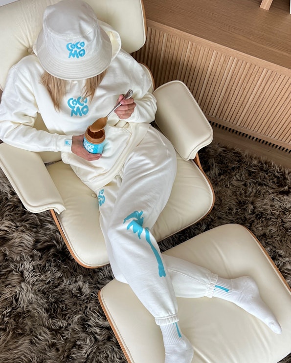 Custom cream fleece sweat set with turquoise palm tree graphics and matching bucket hat, produced by MerchCamp for Starshot Ventures