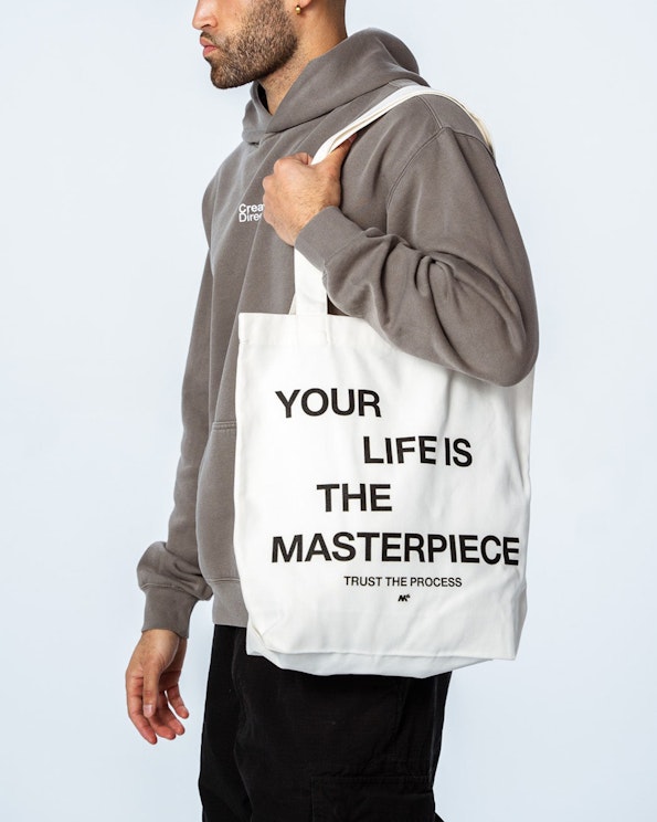 Screen printed white canvas tote bag with bold black motivational typography, produced by MerchCamp for MPower6 Gym