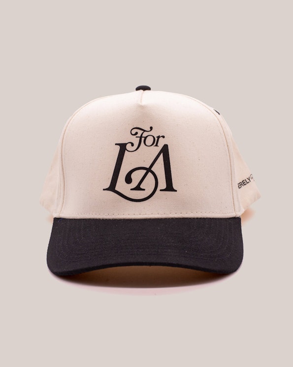 Screen printed cream and black two-tone canvas snapback hat with serif LA graphic, produced by MerchCamp for Community Member