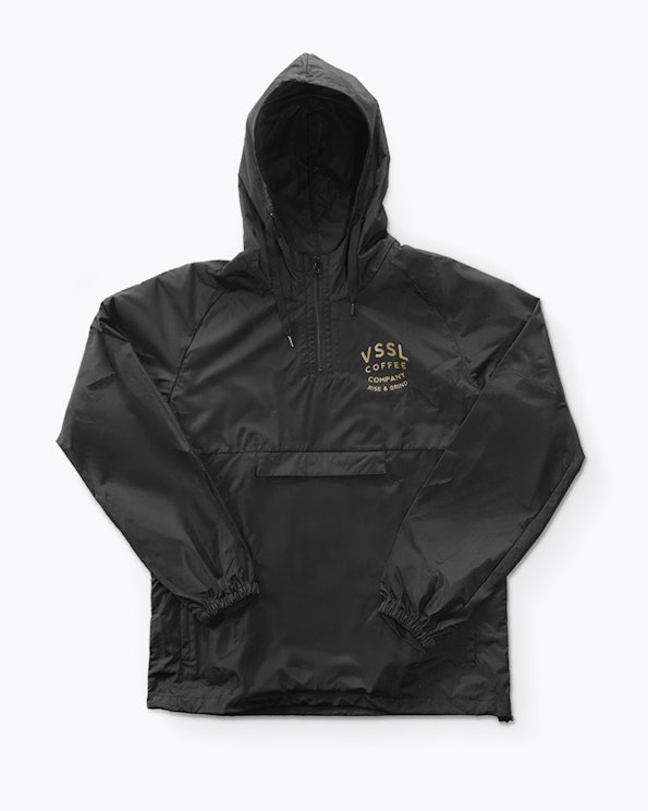 Printed black nylon half-zip anorak windbreaker with gold chest logo and kangaroo pocket, produced by MerchCamp for VSSL Gear