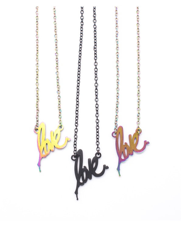 Custom script "love" pendant necklaces in iridescent rainbow and matte black finishes, produced by MerchCamp for Ruben Rojas