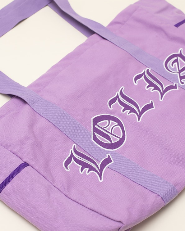Full custom lavender canvas oversized tote with Gothic letter embroidery and logo crest, produced by MerchCamp for Lollapalooza