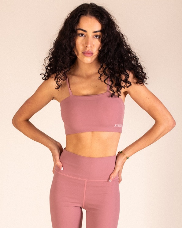 Full custom dusty rose sports bra with square neckline and matching high-waist leggings, produced by MerchCamp for KINRGY