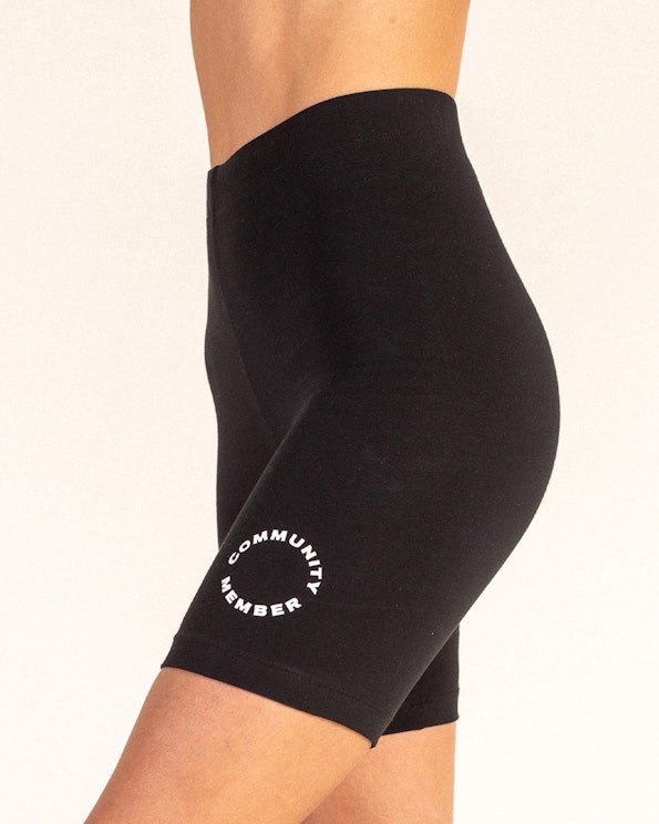 Screen printed black cotton bike shorts with circular community member logo, produced by MerchCamp for Community Member
