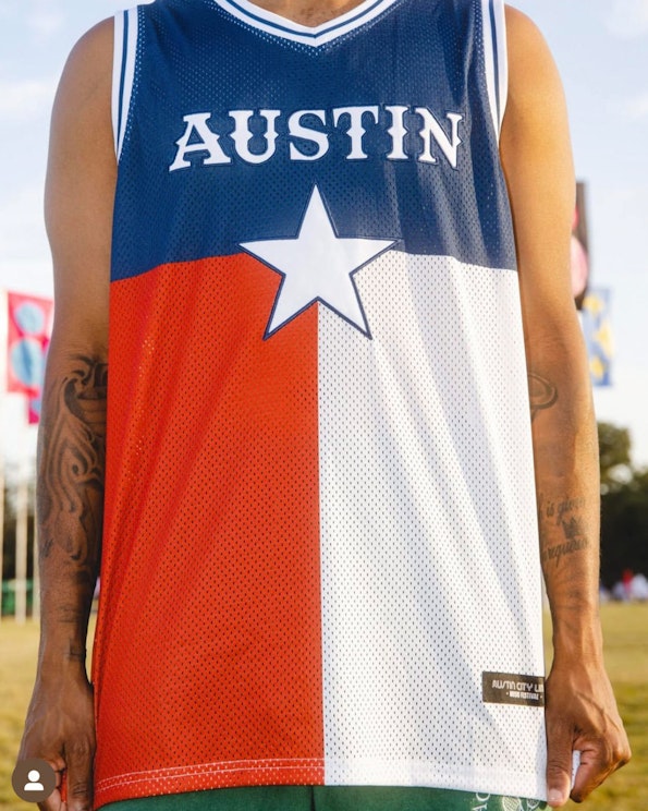 Sublimated Texas flag mesh basketball jersey with navy blue, red, and white star design, produced by MerchCamp for Live Nation