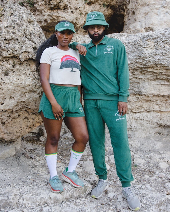 Full custom green French terry tracksuit with embroidered tennis club logo detailing, produced by MerchCamp for Live Nation
