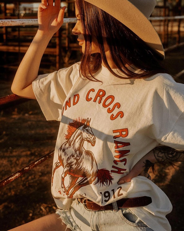 Screen printed cream cotton graphic tee with vintage horse illustration and ranch motif, produced by MerchCamp for Diamond Cross Ranch