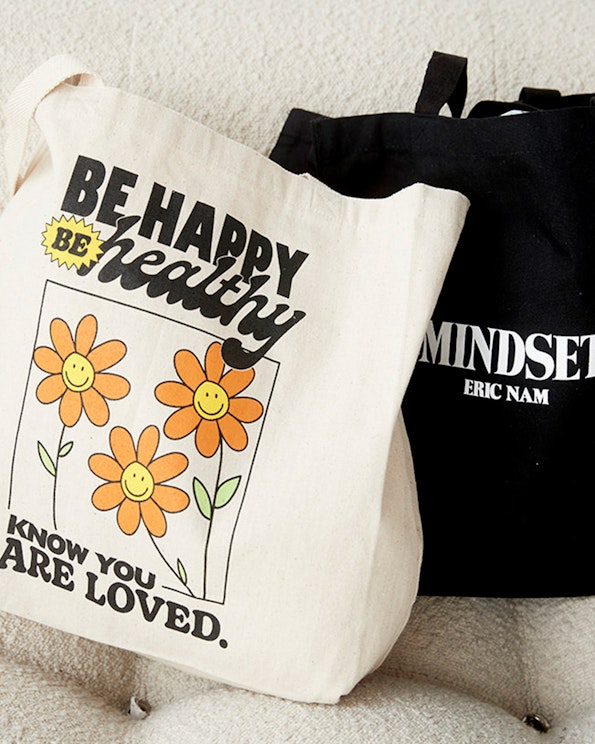 Screen printed natural canvas tote bag with retro smiley daisy graphics, produced by MerchCamp for Mindset