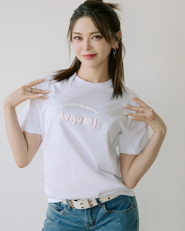 Puff printed white cotton crewneck tee with raised pink "i'm okay" lettering and smile graphic, produced by MerchCamp for Mindset