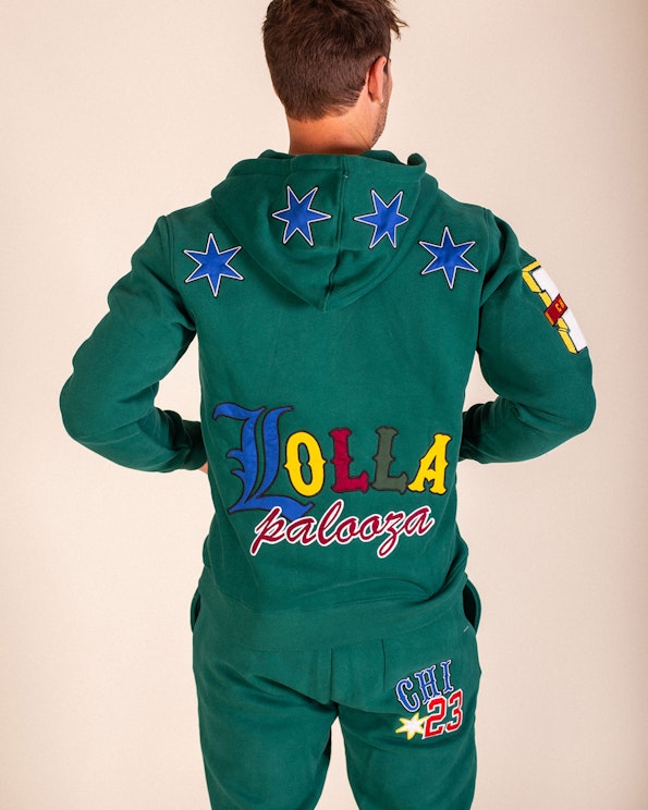 Full custom green fleece hoodie with tackle twill lettering and six-point star patches, produced by MerchCamp for Lollapalooza