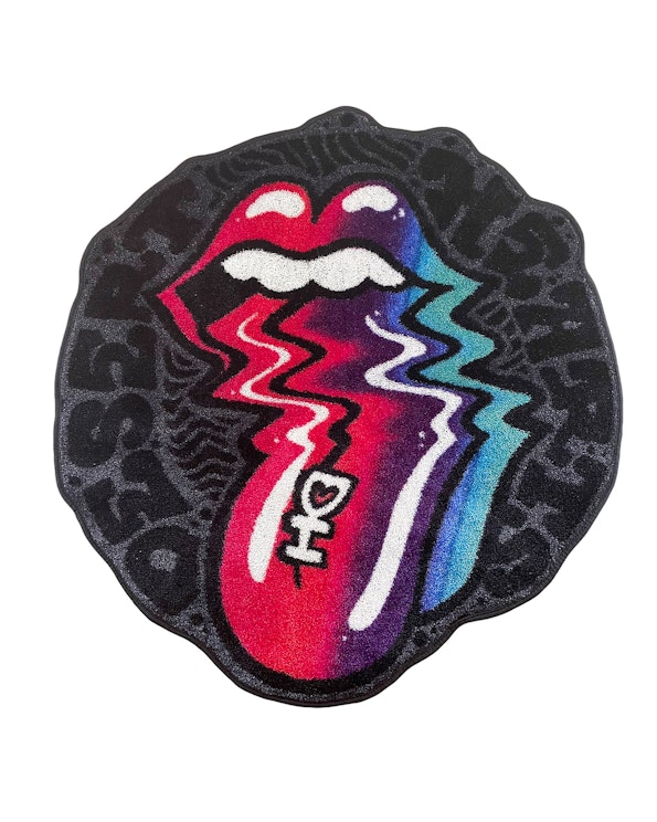 Custom tufted black rug with Rolling Stones-inspired lips and lightning bolt design, produced by MerchCamp for Desert Hearts