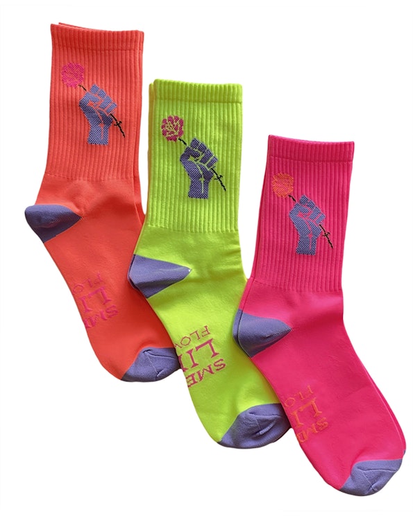 Full custom neon poly knit crew socks with raised fist and rose graphic, produced by MerchCamp for Bloom & Plume