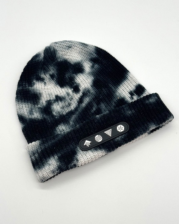 Custom black and white tie-dye knit beanie with rubber logo patch and folded cuff, produced by MerchCamp