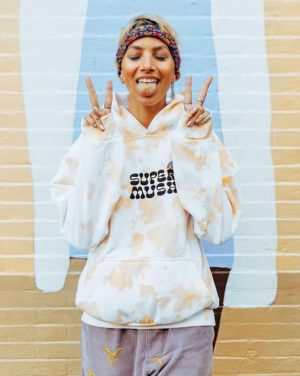 Custom orange tie-dye pullover hoodie with retro black bubble-letter logo on white fleece, produced by MerchCamp for Multiverse