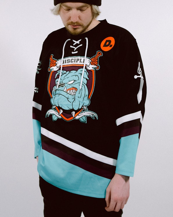 Full custom black and teal hockey jersey with bulldog crest and lace-up neck, produced by MerchCamp for Disciple Records
