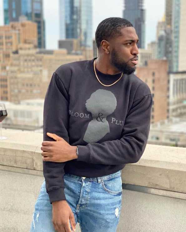 Puff printed black crewneck sweatshirt with tonal silhouette graphic and brand lettering, produced by MerchCamp for Bloom & Plume