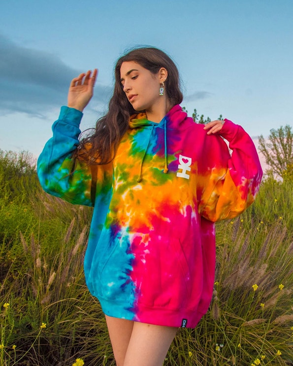 Embroidered rainbow tie-dye pullover hoodie with bold pink and cyan fleece panels, produced by MerchCamp for Desert Hearts