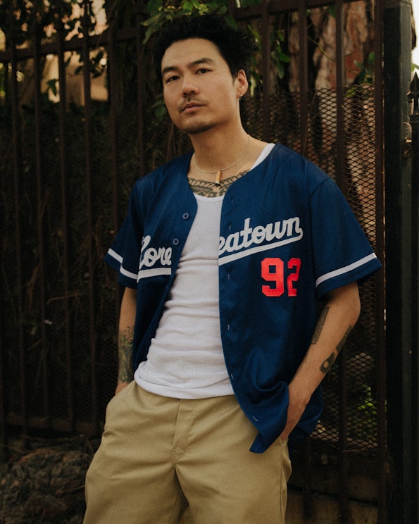 Full custom navy baseball jersey with white script lettering and red #92, produced by MerchCamp for Dumbfoundead