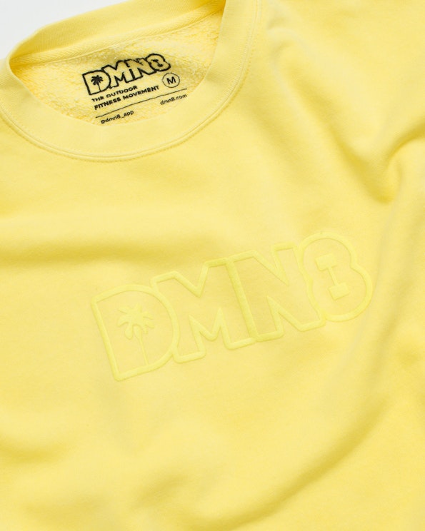 Puff printed yellow fleece crewneck sweatshirt with tonal raised letter logo and palm tree, produced by MerchCamp for DMN8