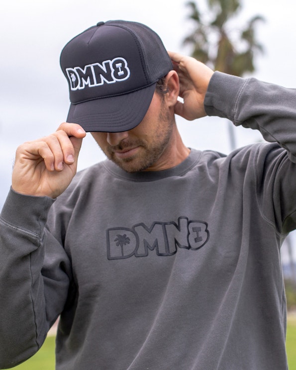 Puff printed charcoal crewneck sweatshirt with tonal raised DMN8 logo and palm tree motif, produced by MerchCamp for DMN8
