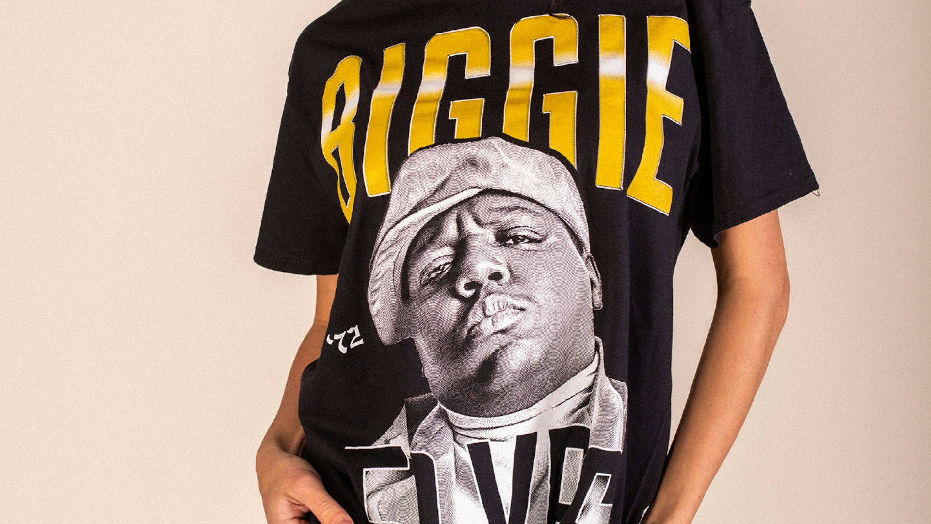 Black oversized graphic tee featuring Biggie Smalls portrait with yellow text, worn casually — Biggie Smalls merchandise by MerchCamp