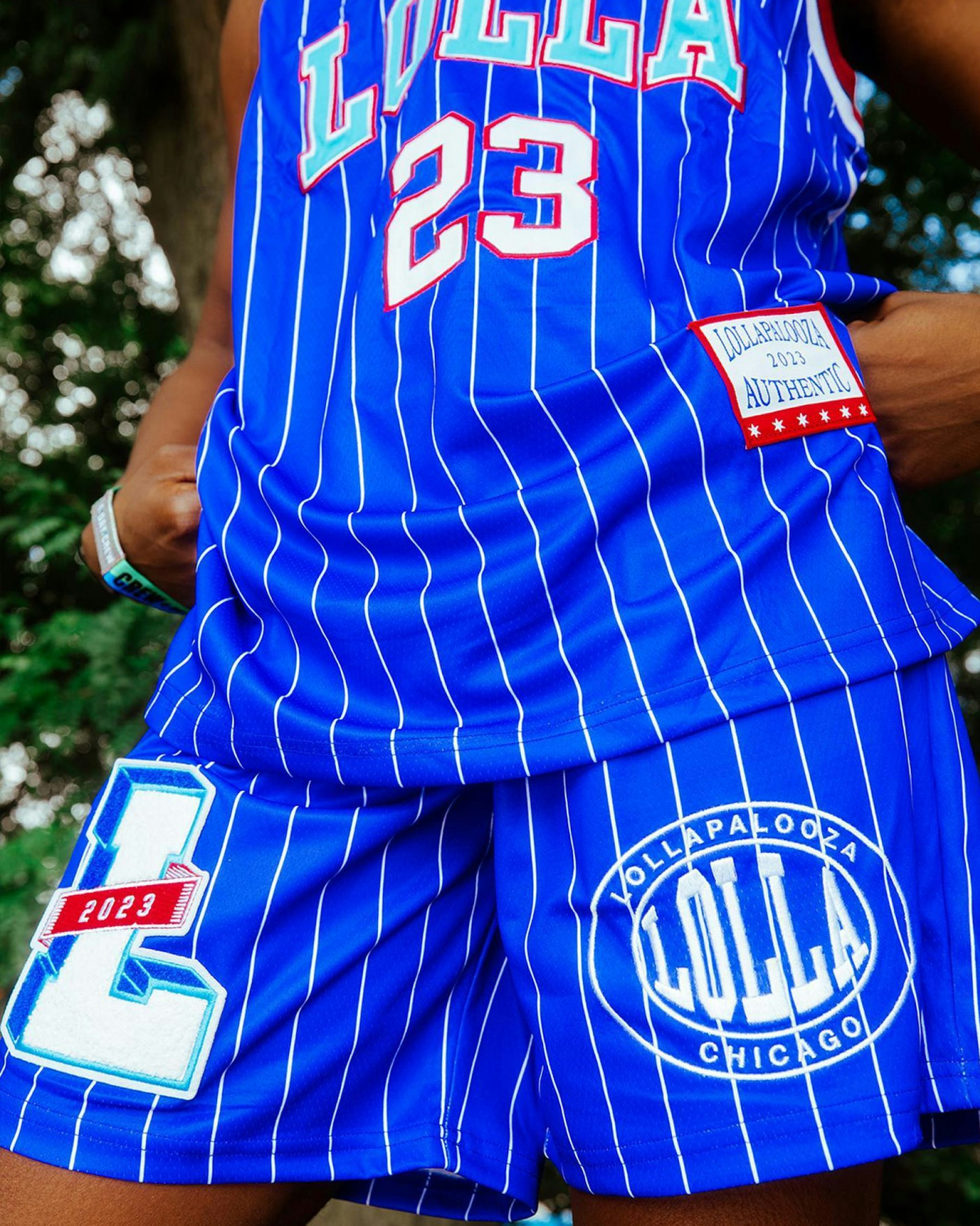 Blue pinstripe basketball jersey and shorts set with Lollapalooza 2023 Chicago branding — Lollapalooza merchandise by MerchCamp