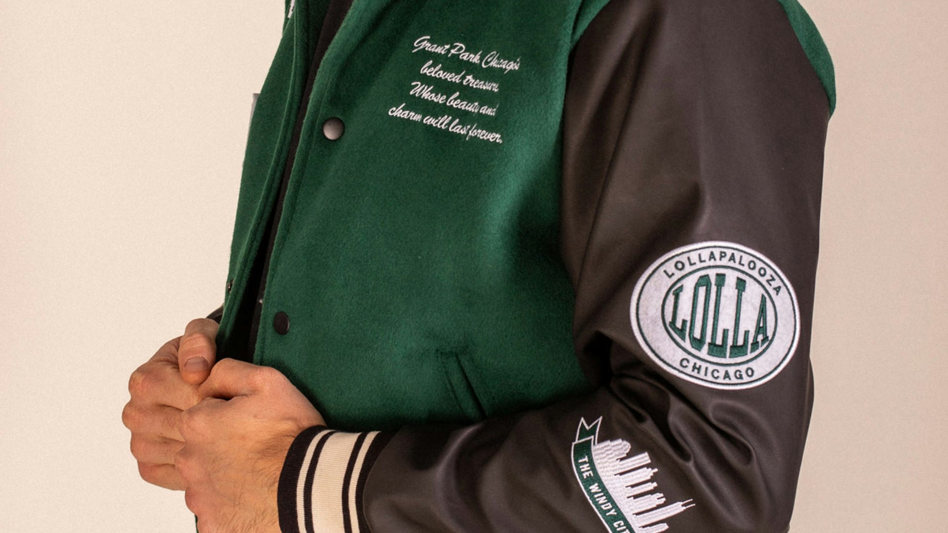 Close-up of green and black Lollapalooza varsity jacket with embroidered patches and script — Lollapalooza merchandise by MerchCamp