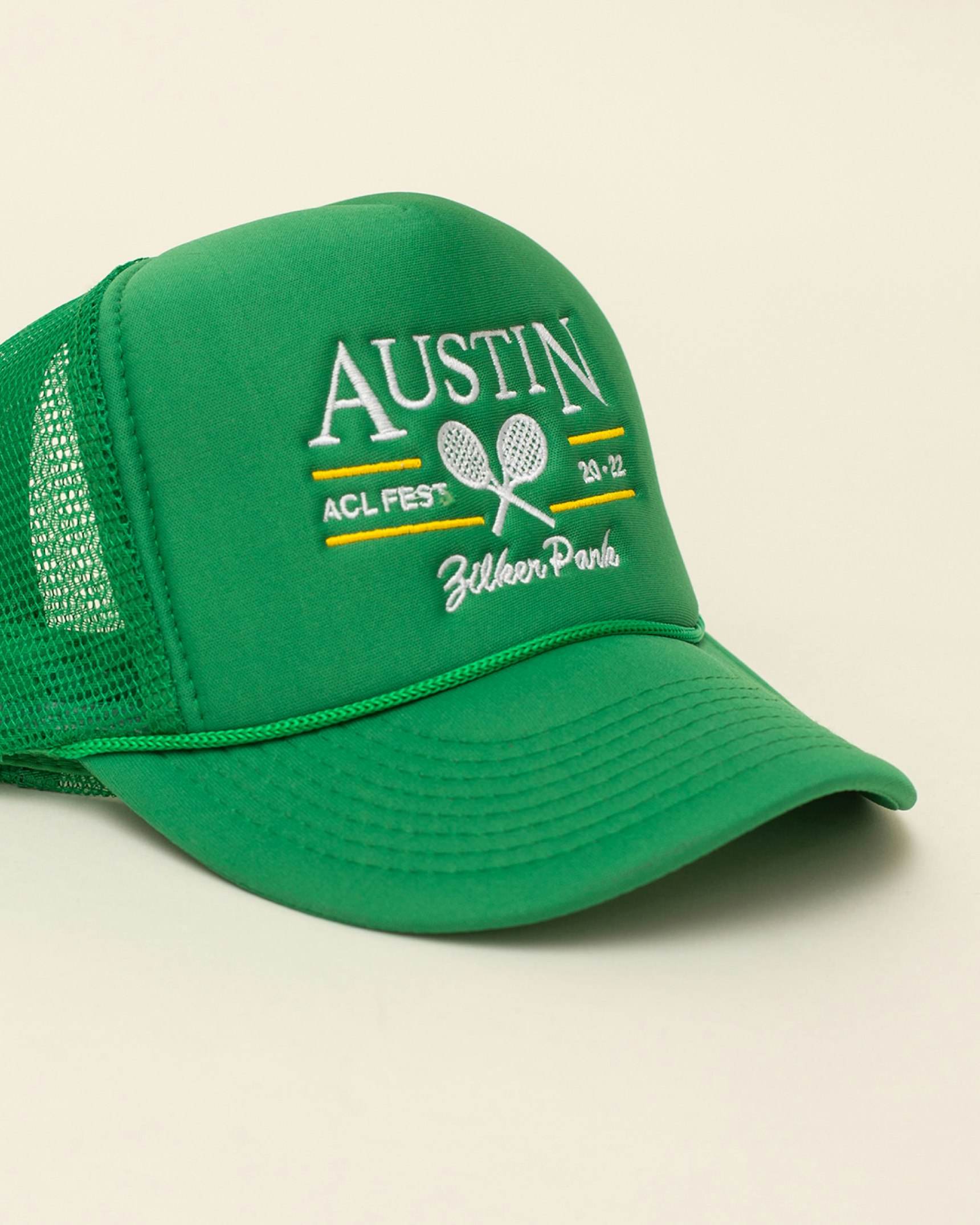 Green trucker hat with white embroidered Austin ACL Fest Zilker Park design and mesh back — Live Nation merchandise by MerchCamp