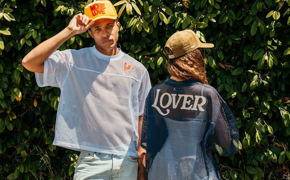Two people wearing custom Ruben Rojas More Love and Lover branded mesh jerseys and trucker caps, produced by MerchCamp for Ruben Rojas