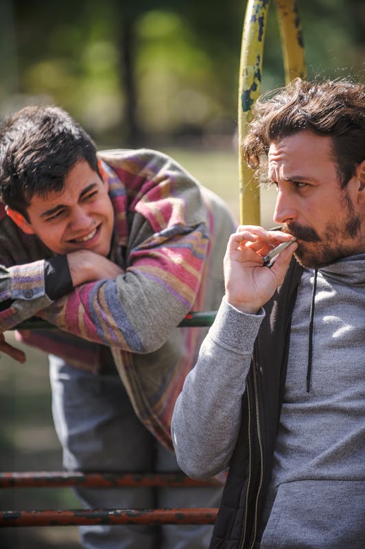 two guys smoking a joint